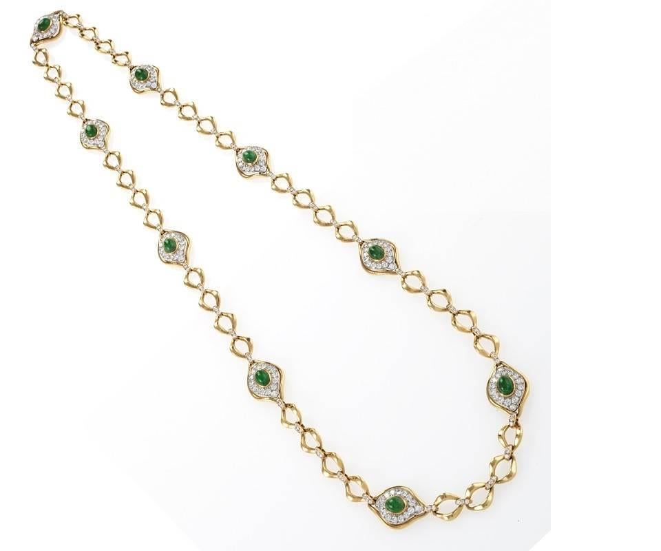 A French 18 karat gold and platinum long necklace with diamonds and emeralds by O.J. Perrin Paris. This necklace has 9 emerald and diamond plaques set with 279 round cut diamonds including diamond links that connect the gold chain links. The