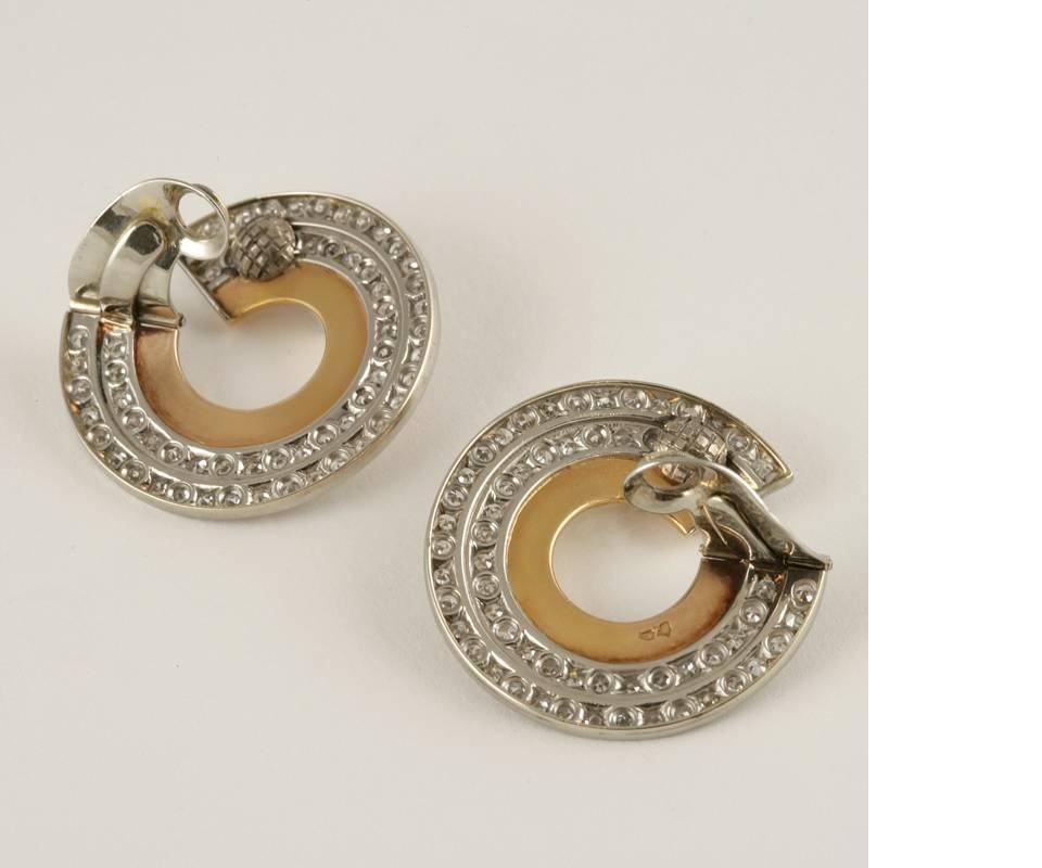 A pair of French Art Deco 18 karat gold earrings with diamonds. The earrings have 122 old European-cut diamonds with an approximate total weight of 4.90 carats, H/I color, VS clarity.  The earrings are composed in a strong Art Deco motif as three