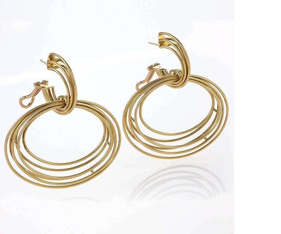 A pair of Modernist 18 karat gold hoop earrings composed of 6 concentric circles in an architectural motif. Fully articulated. Circa 1970's.

Signed, 