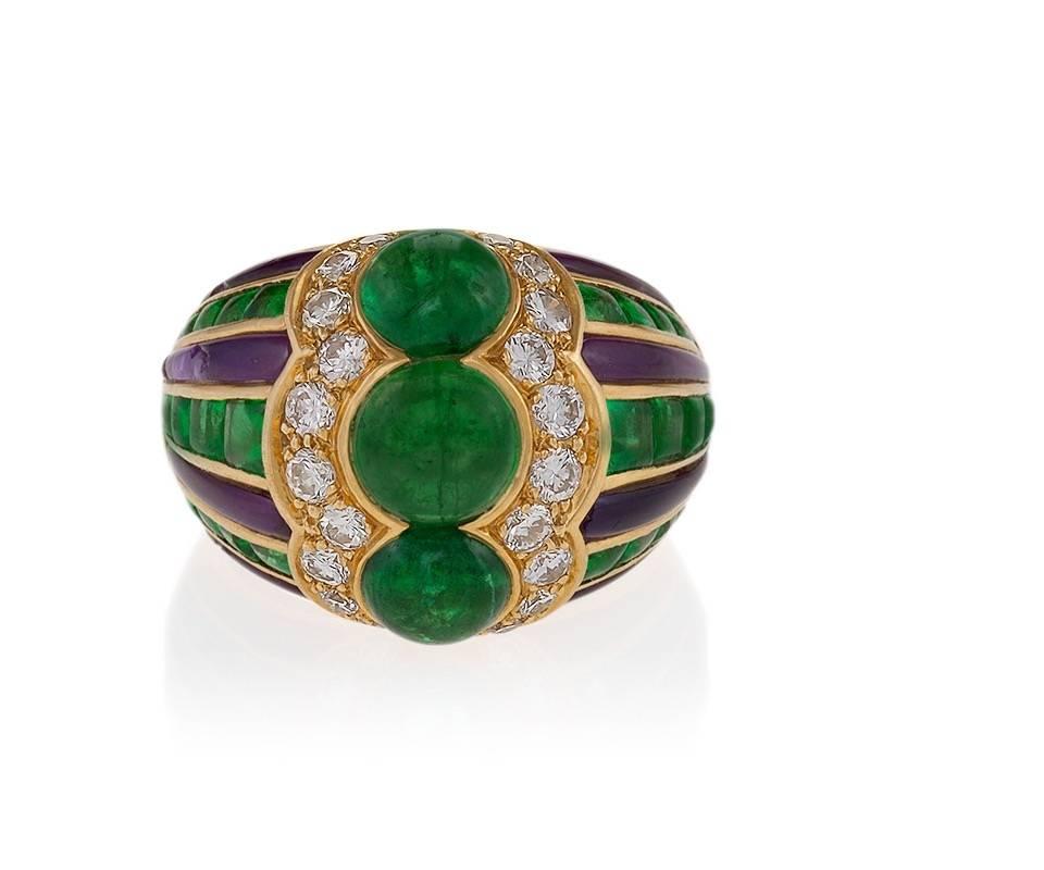 A French made Late-20th Century polished 18 karat gold ring with emerald, diamond and amethyst by Bulgari. The ring has 3 cabochon emeralds with an approximate total weight of 5.22 carats, 30 calibre buff-cut emeralds with an approximate total