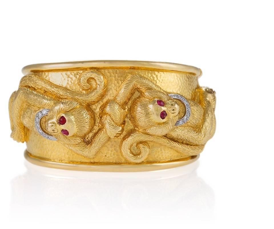 An American Estate 18 karat gold and platinum cuff bracelet with rubies and diamonds by David Webb. The cuff bracelet has 4 cabochon rubies with an approximate total weight of .28 carats, and 14 pavé- set diamonds with an approximate total weight of