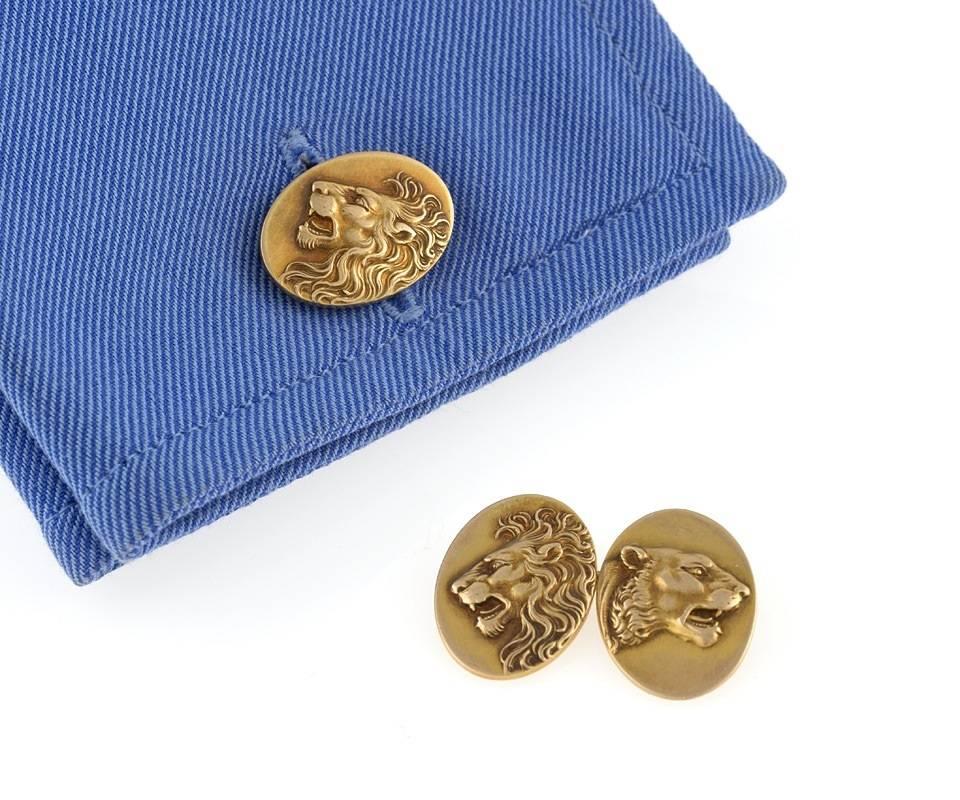 A pair of American Art Nouveau 14 karat gold double sided cufflinks. The oval cufflinks represent male and female lion heads in relief.

Pictured in “Art Nouveau Jewelry”, by Vivienne Becker, E. P. Dutton, 1985, page , Plate 30. Circa 1900.