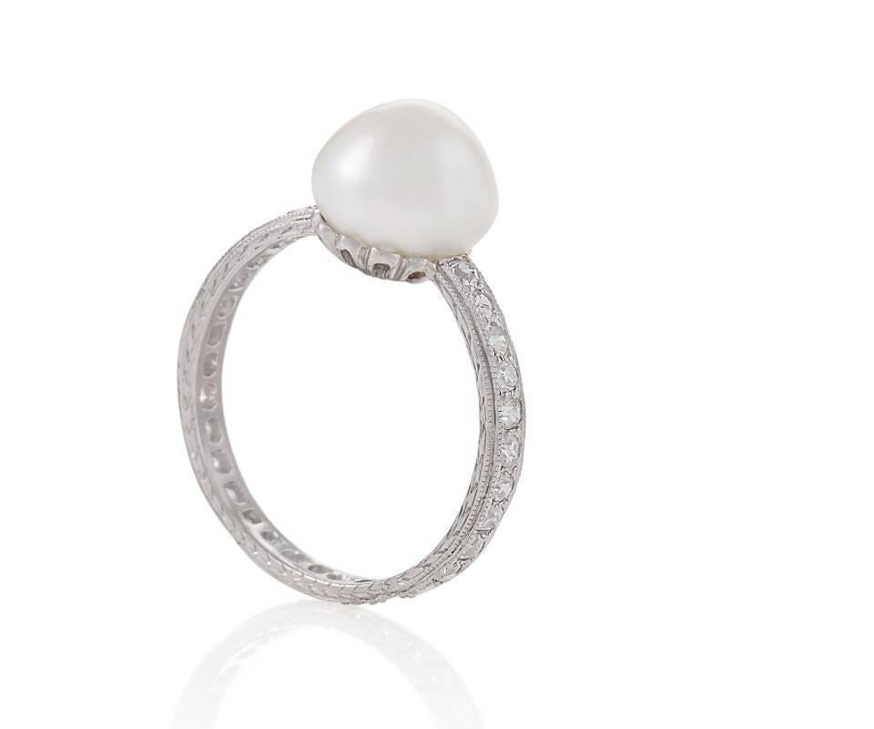 An Edwardian platinum ring with diamonds and pearl. The ring has 30 single-cut diamonds, continuously set, with an approximate total weight of .30 carats, and a natural saltwater pearl measuring 8.80 mm.  Circa 1910.

GIA Report #2165959361 stating