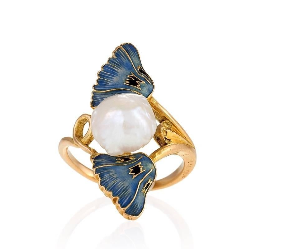 A French Art Nouveau 18 karat gold, enamel, and pearl ring by René Lalique. The ring has a freshwater baroque pearl measuring approximately 8.85 x 9.01 x 6.5 mm. and two enamel poppies. Circa 1900.
Signed, "Lalique". 
Pictured in René