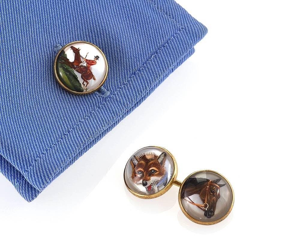 A pair of American cuff links composed of Essex crystals by Marcus & Co. The double sided cuff links have 4 finely executed individual reverse painted Essex Crystals. The crystals depict a jumping horse and rider, hunting dog, horse and fox head.