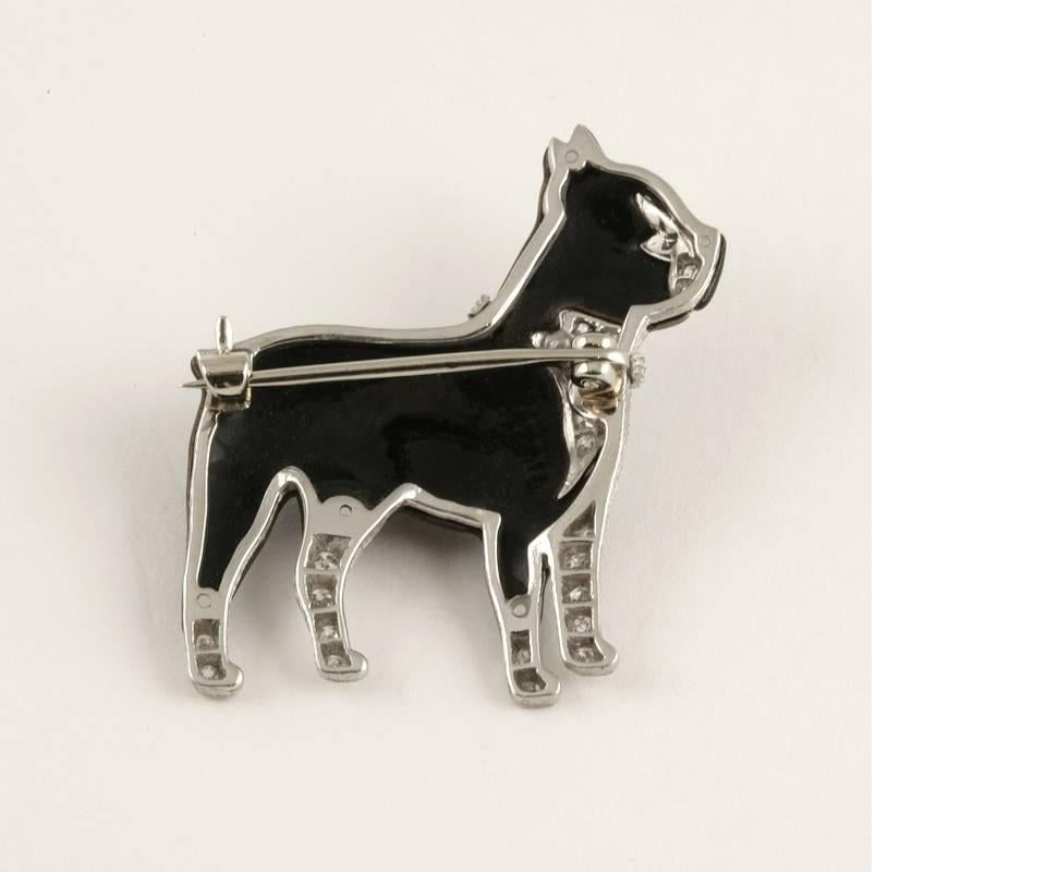 An Art Deco platinum and black enamel Boston Terrier dog brooch with diamonds. The brooch has 29 round single-cut diamonds with an approximate total weight of 0.23 carat. The dog is designed in a strong stylized Art Deco motif with fine engraved
