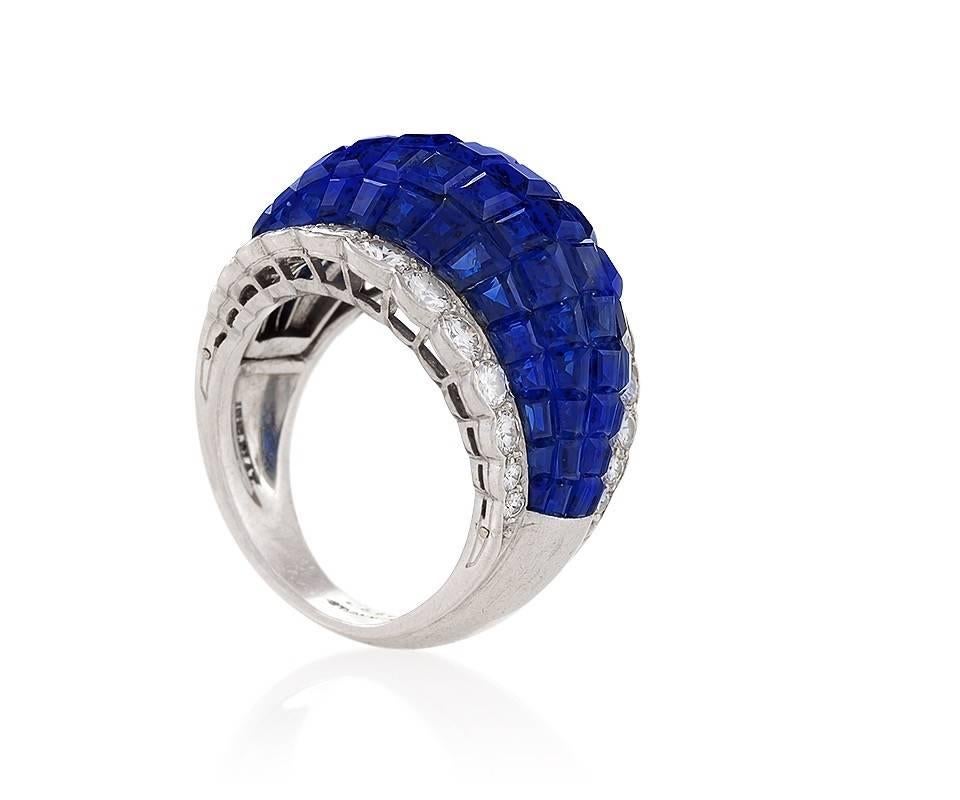 A Mid-20th Century platinum ring with sapphires and diamonds by Van Cleef & Arpels. The ring has 80 invisibly set sapphires  with an approximate total weight of 17.75 carats, and 26 round diamonds with an approximate total weight of 1.70 carats,