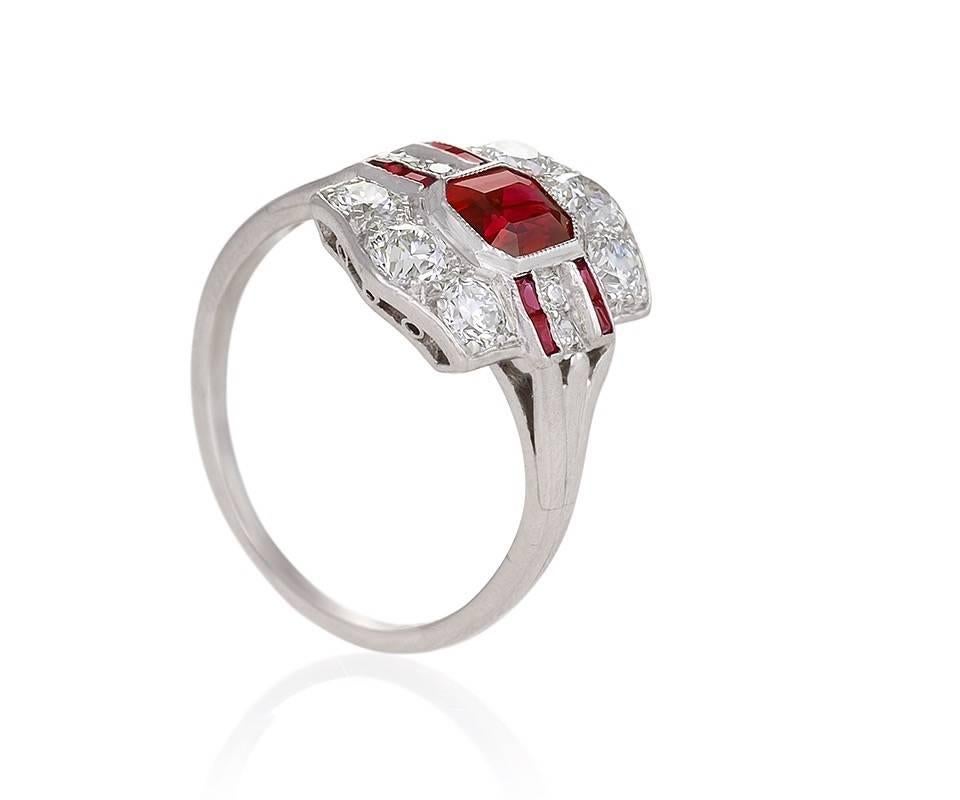 A platinum Art Deco ring with rubies and diamonds by Tiffany & Co. The ring centers on an emerald-cut ruby with an approximate weight of 1.10 carats, and 6 old European-cut diamonds with an approximate total weight of .70 carat. The ring is designed