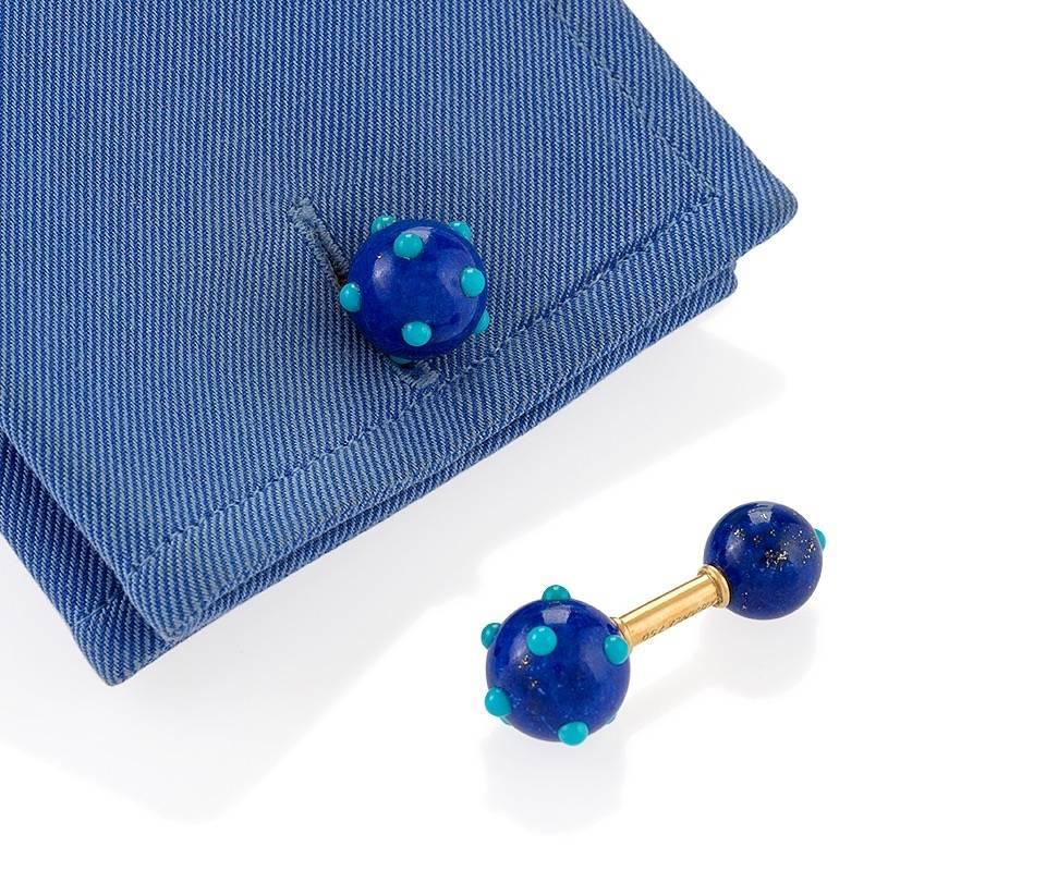 A pair of French Mid-20th Century 18 karat gold cuff links with lapis lazuli and turquoise by Jean Schlumberger for Tiffiany & Co.. The cuff links have a total of 22 cabochon turquoise stones set into the 4 lapis lazuli balls. Circa 1960's.

Similar