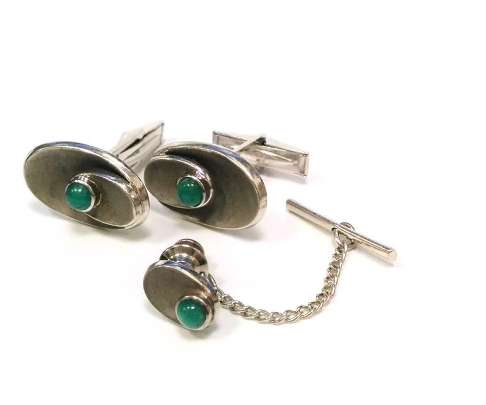 A pair of Mid-20th Century 14 karat gold cuff link set with chrysophrase. The cuff link set has 3 cabochon chrysophrase stones. It consists of a pair of cuff links and tie tack designed in a highly stylized Modernist Mid-20th Century motif.   Circa