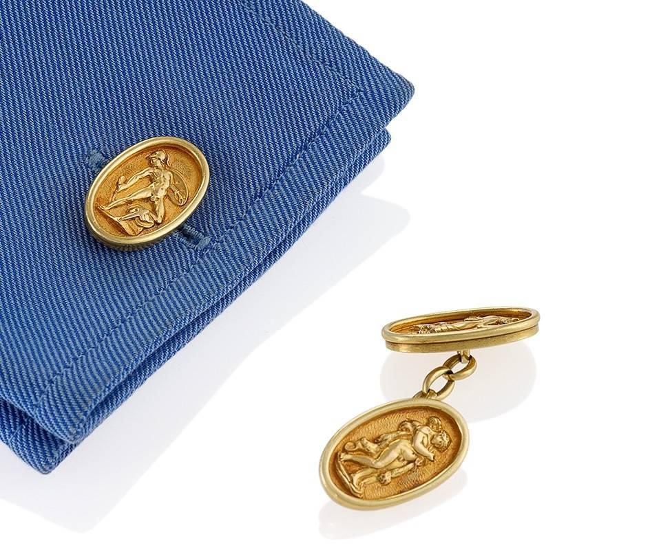 A pair of Antique 18 karat gold cuff links. The bezel edged oval cuff links depict Greek Gods and Goddess in relief. Double sided. Circa 1900.

(MG #18179)