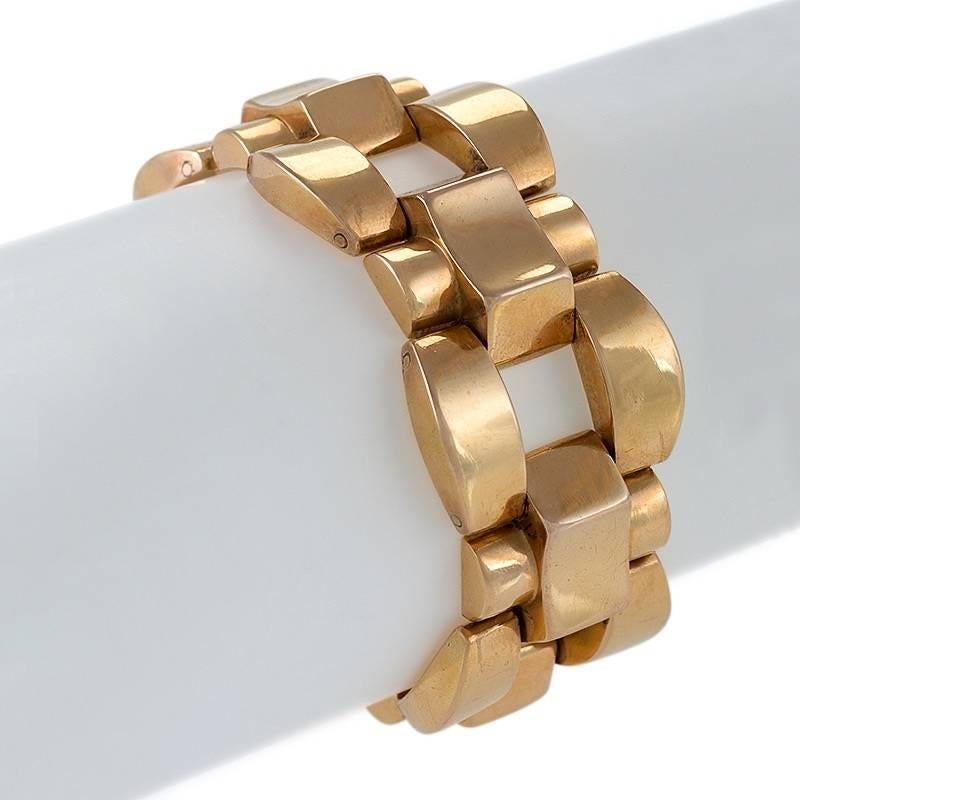 This gold French Retro tank track bracelet dates from the 1940s. Composed of articulated links, the geometric design incorporates arches, reverse curves, and hemispheres into a beautiful composition of volume and negative space, creating a bold