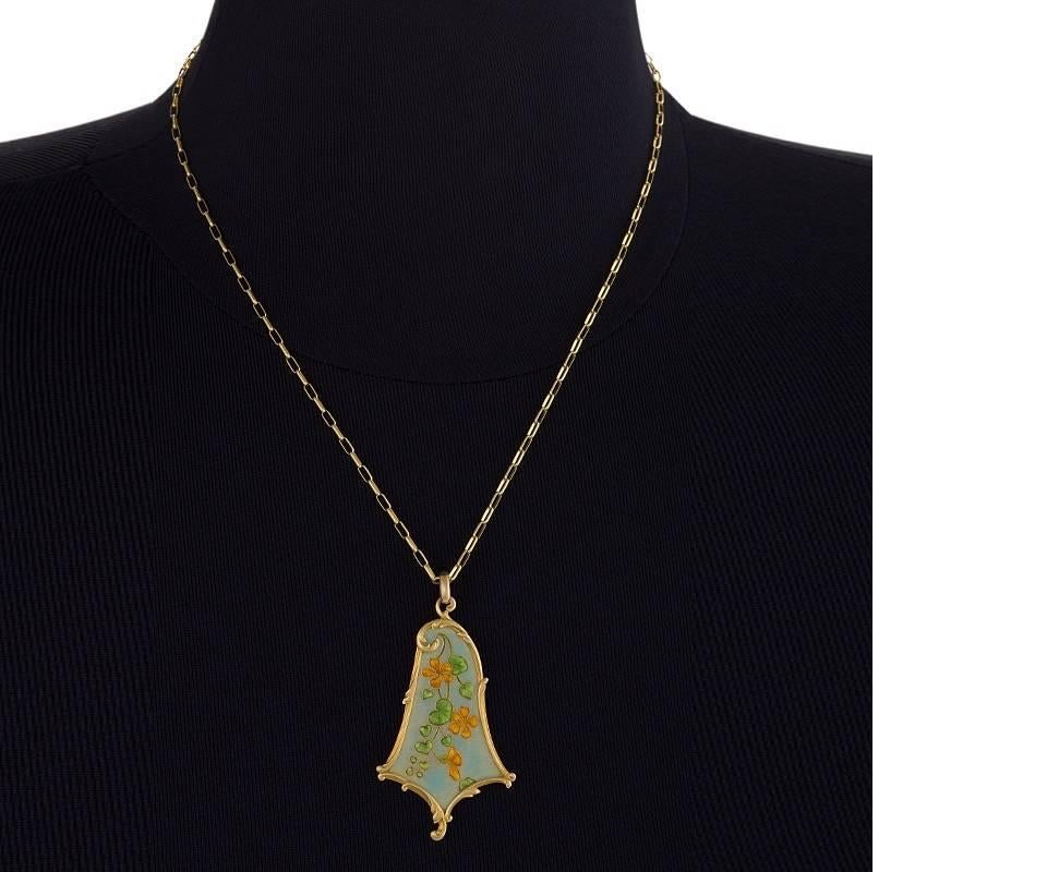 A French Art Nouveau 18 karat gold and enamel pendant necklace by Eugène Feuillâtre. The bell shape pendant is enameled in a whimsical flower and heart shaped leaf vine motif. Chain later. Circa 1900.

Signed, Feuillâtre house and French control