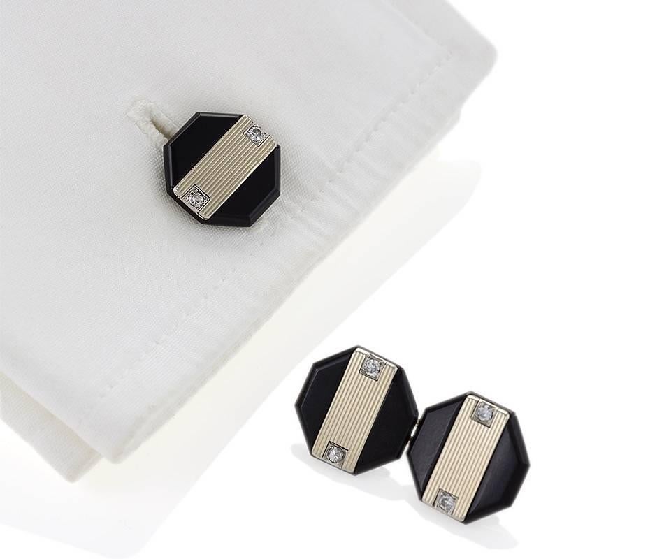 A pair of  French Art Deco platinum and white gold cuff links with diamonds and black onyx by Ghiso. The cuff links have 8 single-cut diamonds with an approximate total weight of .08 carat. The ribbed panels are white gold, and the diamonds are set