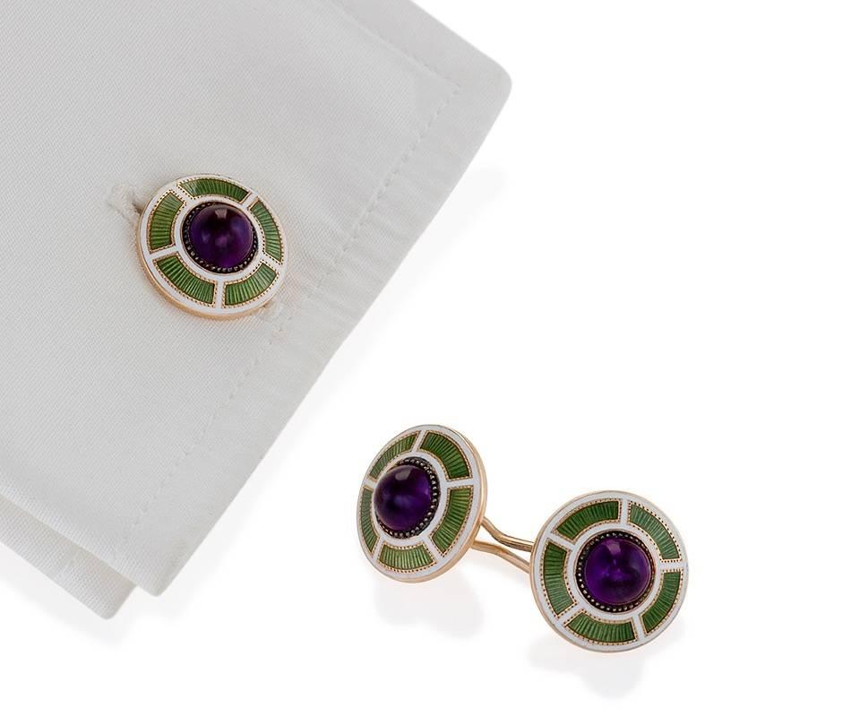 A pair of Art Deco 14 karat gold and guilloche enamel cuff links with amethysts. The cuff links have 4 cabochon amethysts with an approximate total weight of 3.40 carats surrounded by green and white Art Deco graphic guilloche enamel. Double sided.