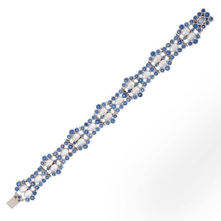 An American Art Deco platinum bracelet with moonstones and sapphires by Tiffany & Co. The bracelet has 20 cabochon moonstones with an approximate total weight of 8.00 carats, and 127 round-cut Montana sapphires with an approximate total weight of