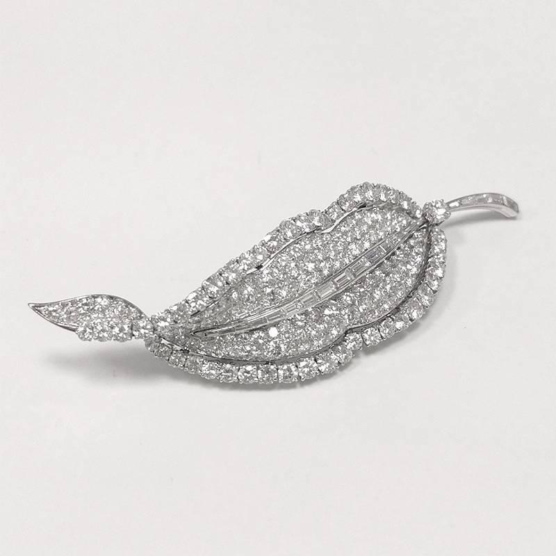 Created by Bulgari in Rome, this platinum leaf brooch, set with ten carats of diamonds, dates from the 1960s. Pavé-set with round brilliant-cut diamonds, the brooch is further highlighted by a channel-set baguette diamond stem and spine. With its