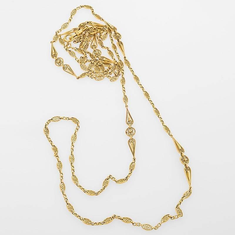 A French Art Nouveau 18 karat gold long chain. The chain is composed of alternating Art Nouveau wire work motif links and round links. Circa 1895-1900.
Signed, French assay and Maker's marks (partial). 

(MG #18133)