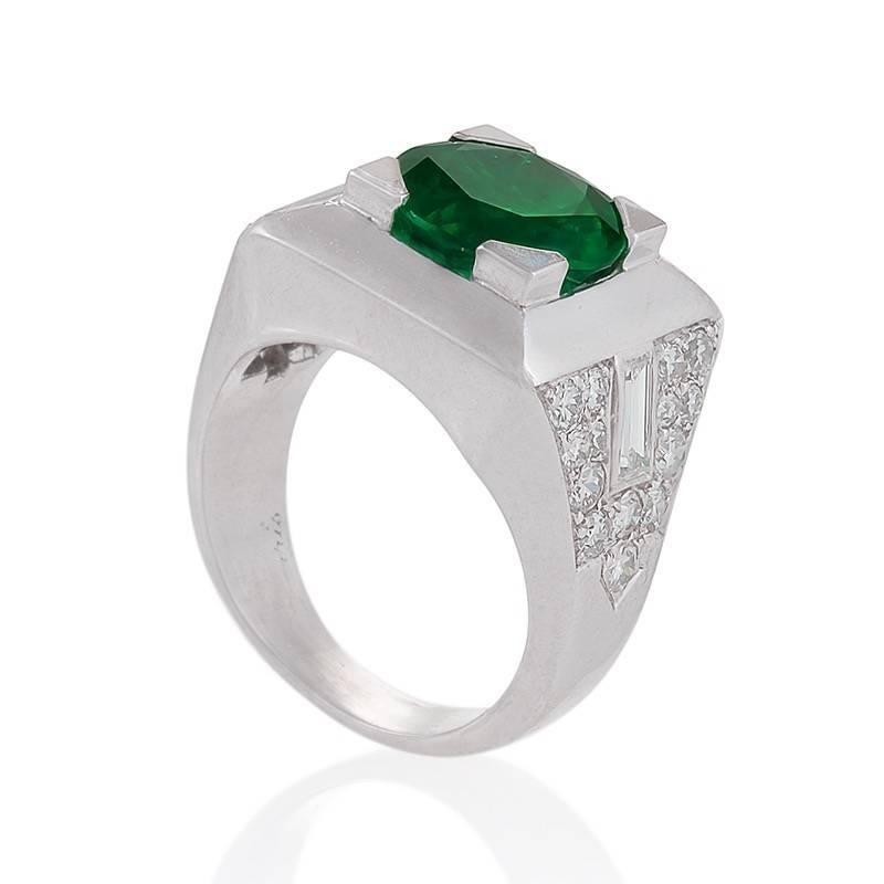 This Colombian emerald and diamond ring by Cartier has incredible outsize presence, with over three-and-a-half carats in its beautiful center stone. The geometry of an emerald circle, inscribed in a canted frame of polished platinum, is enhanced by