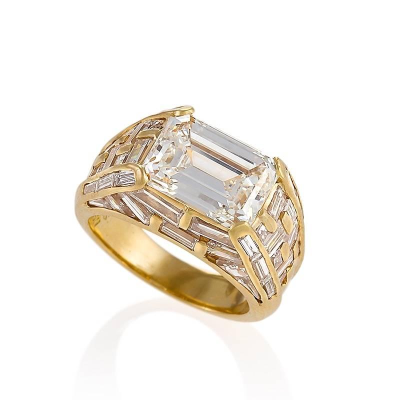 An Italian Estate 18 karat gold ring with diamonds by Bulgari. This ring centers on an emerald-cut diamond, 4.01 carats, H color, VS-2 clarity. The architectural setting has 50 baguette-cut diamonds with an approximate total weight of 2.80 carats. 