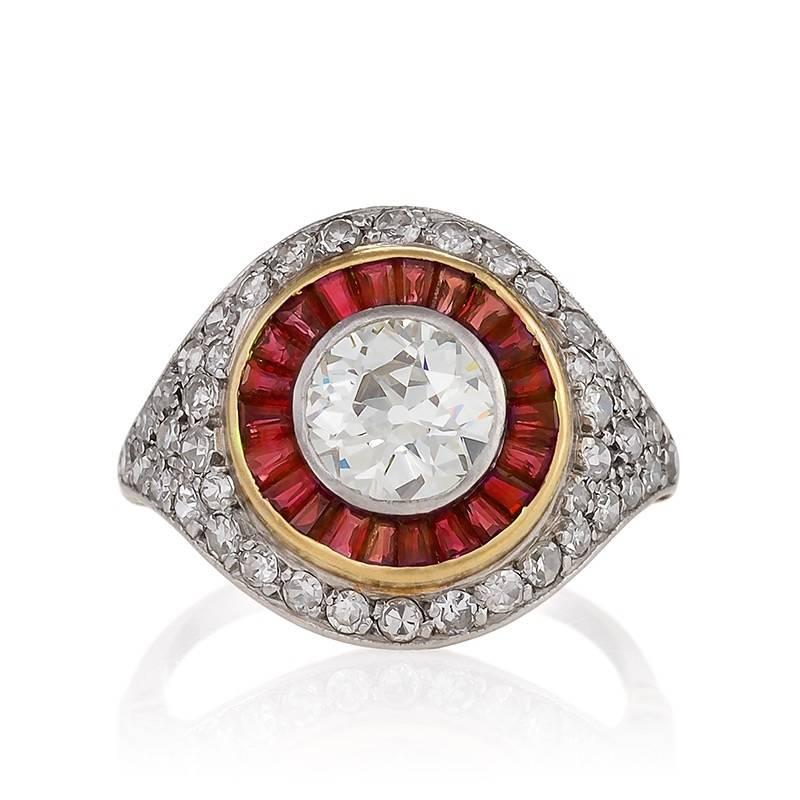 An Art Deco platinum ring with diamonds and rubies. The ring has an old European-cut diamond with an approximate total weight of 1.70 carats,  I-J color, VS clarity, and additional old European-cut diamonds with an approximate total weight of .65