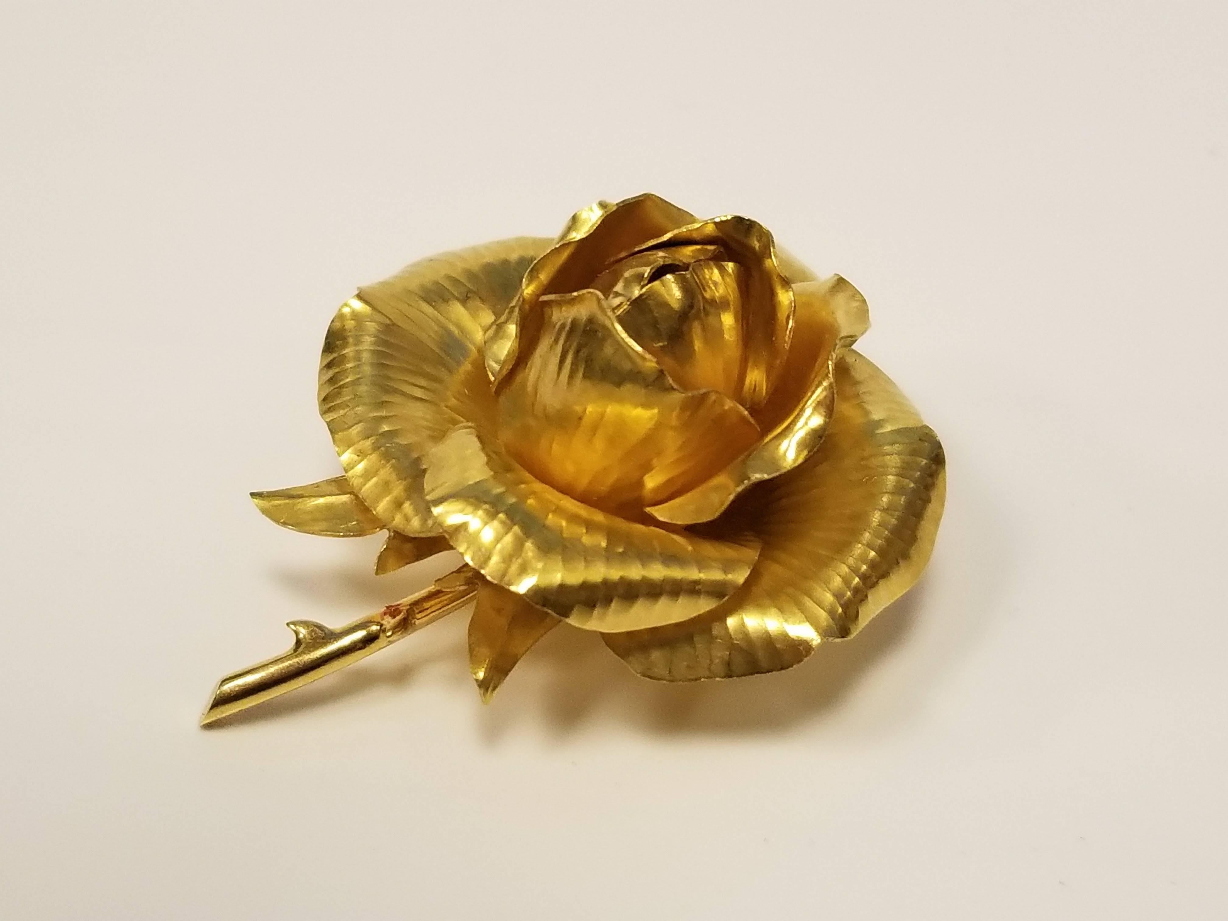 A French Mid-20th Century 18 karat gold brooch by Hermes. The dimensional, textured gold brooch is designed in a bloomed rose motif. Circa 1960's.

Signed, 