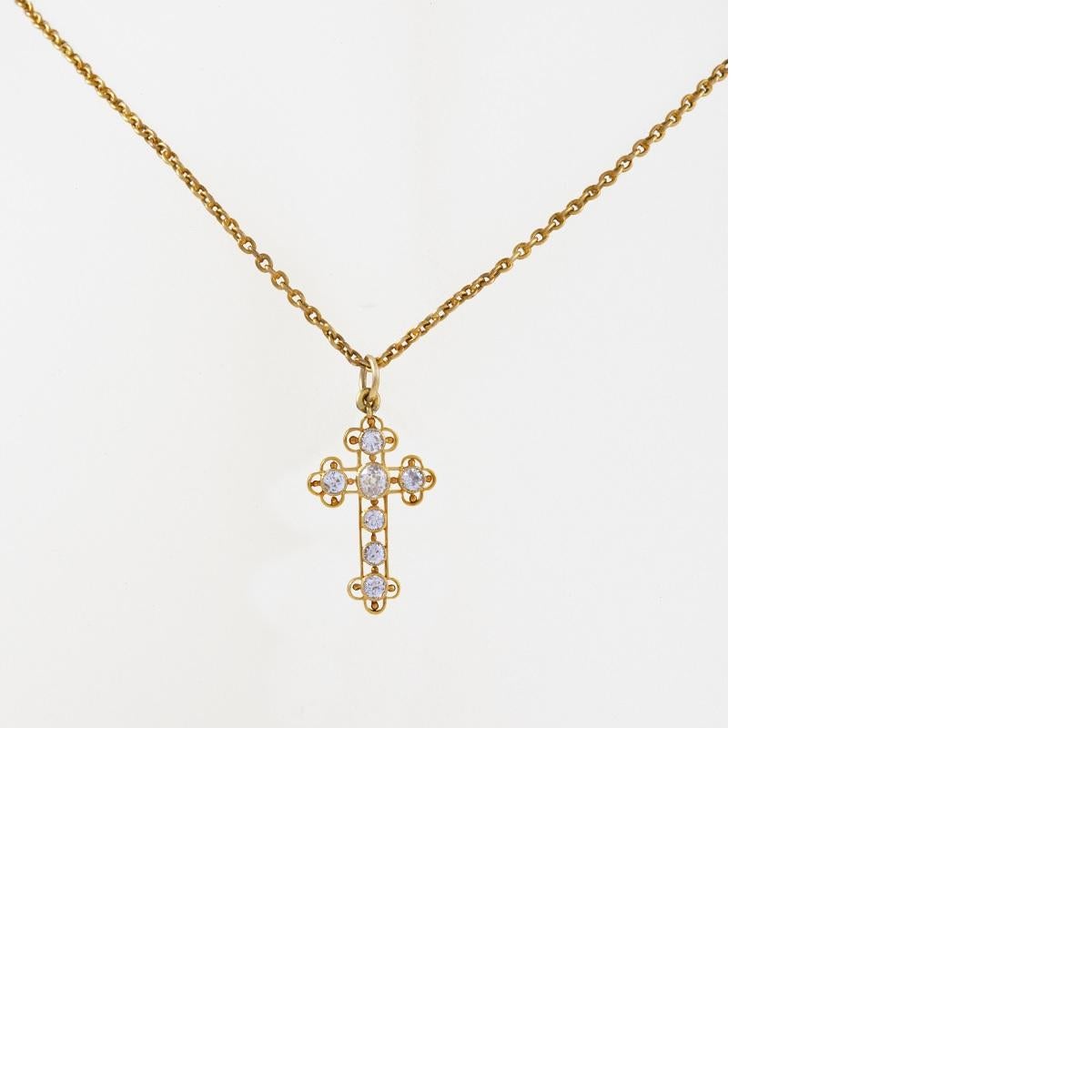 An 18 karat cross pendant with diamonds. The cross, done in delicate filigree work is studded with six Old European Cut diamonds with an approximate total weight of .75carat.

Chain length: 19-1/2