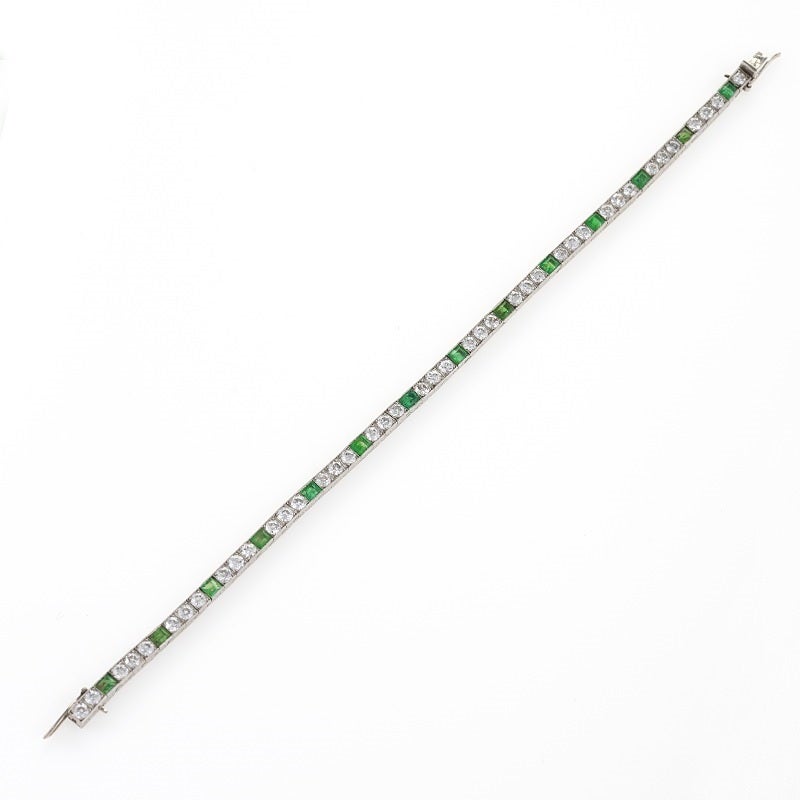 A French Art Deco platinum bracelet with emeralds and diamonds by Van Cleef & Arpels. The bracelet has 14 emerald-cut emeralds with an approximate total weight of 2.10 carats, and 42 round-cut diamonds with an approximate total weight of 2.95