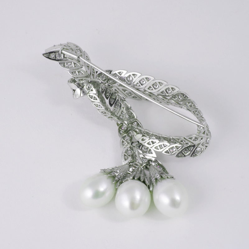 This spectacular brooch, set with round brilliant-cut diamonds and South Sea pearls, demonstrates the dynamic forms and flowing lines for which Pierre Sterlé’s artistic designs were celebrated. Modeled as flexible entwined platinum fronds of