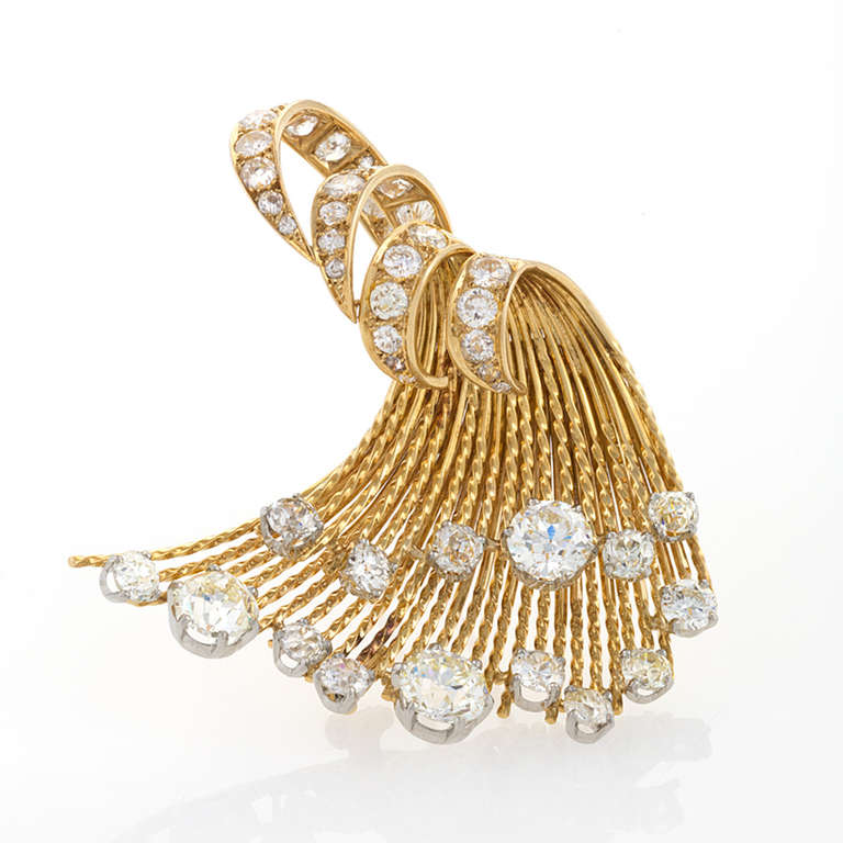 A French Mid-20th Century 18 karat gold and platinum brooch with diamonds by Sterlé. The brooch has 3 large old European-cut diamonds with an approximate total weight of 4.60 carats, with additional old European-cut diamonds with an approximate