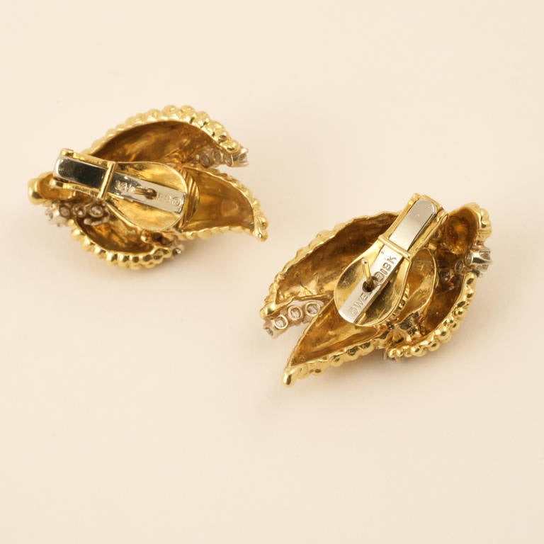 A pair of American Mid 20th Century 18 karat gold ear clips with diamonds by David Webb. The earrings have 30 round-cut diamonds with an approximate total weight of 1.86 carats. The bubble textured gold earrings are in a leaf motif in 3 sections