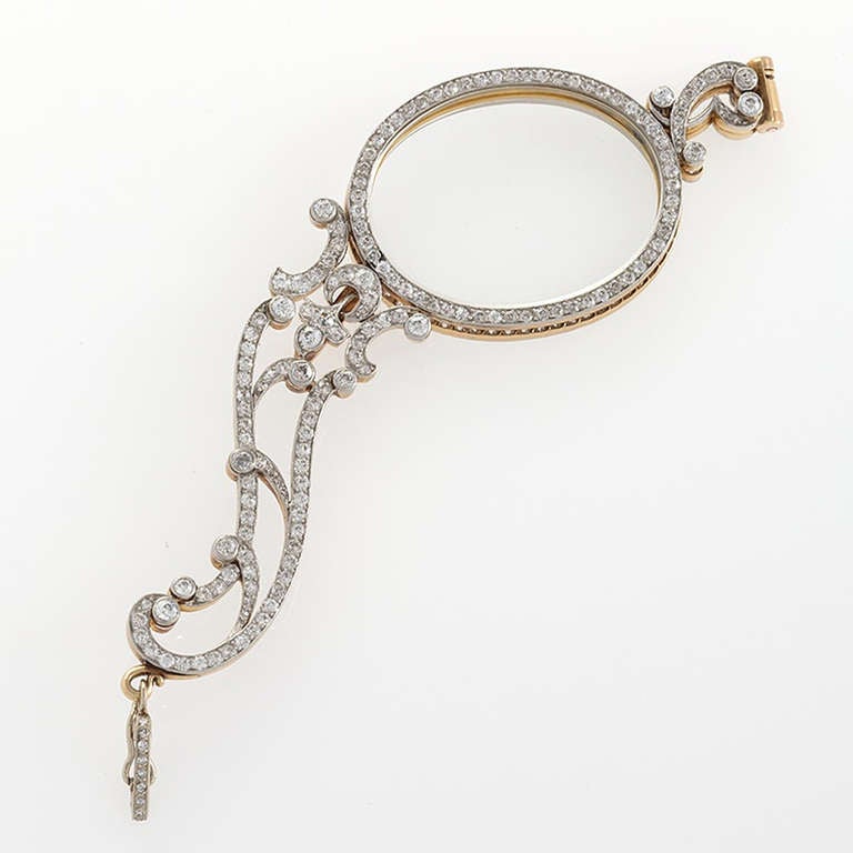 An Art Nouveau platinum and 18 karat gold lorgnette with diamonds. The lorgnette has 244 old European-cut diamonds with an approximate total weight of 6.25 carats in a beautiful scrolling platinum topped gold frame. Circa 1900.