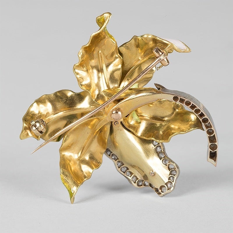 An Art Nouveau 18 karat gold and enamel brooch with diamonds, attributed to Vever. The three dimensional brooch has 3 old mine-cut diamonds with an approximate total weight of .45 carat and 57 rose-cut diamonds with the approximate total weight of