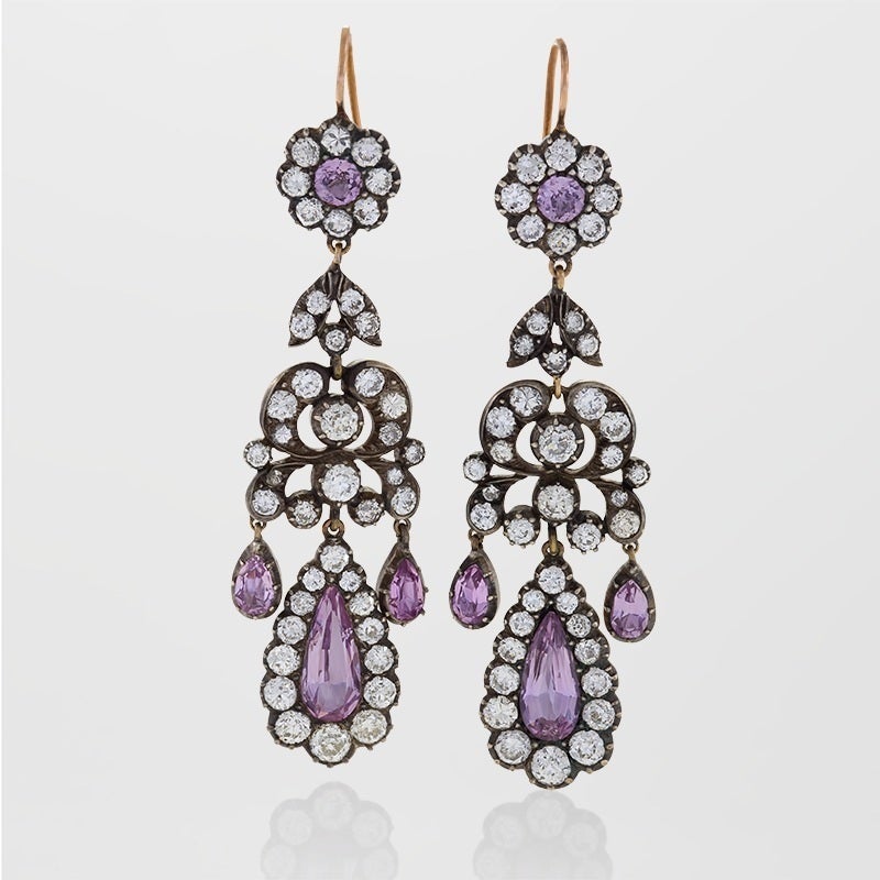 A pair of English Antique 15 karat gold and oxidized silver earrings with diamonds and pink topaz. The earrings have 86 round old European-cut diamonds with an approximate total weight of 7.20 carats, and 8 pear and round-cut pink topaz stones with