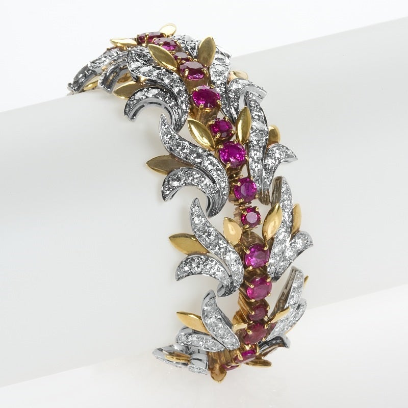 Composed of over eight carats of rubies and nearly thirteen carats of diamonds mounted in platinum and gold, this Tiffany & Co. bracelet is a mid-century jewel dating from the 1950s. The flexible form is designed as a line of oval- and circular-cut