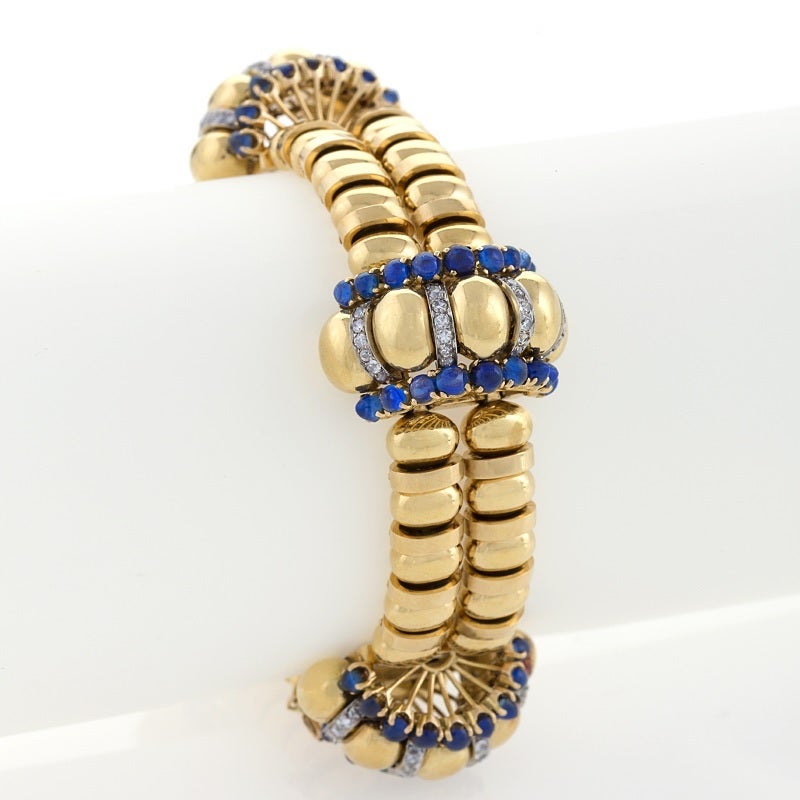 Dating from the 1930s, this gold, sapphire, and diamond bracelet is by Boucheron Paris, a leading jewelry house exploring the newly rounded forms and sweeping lines of Art Moderne. Composed of four hemi-spherical, arched motifs outlined in