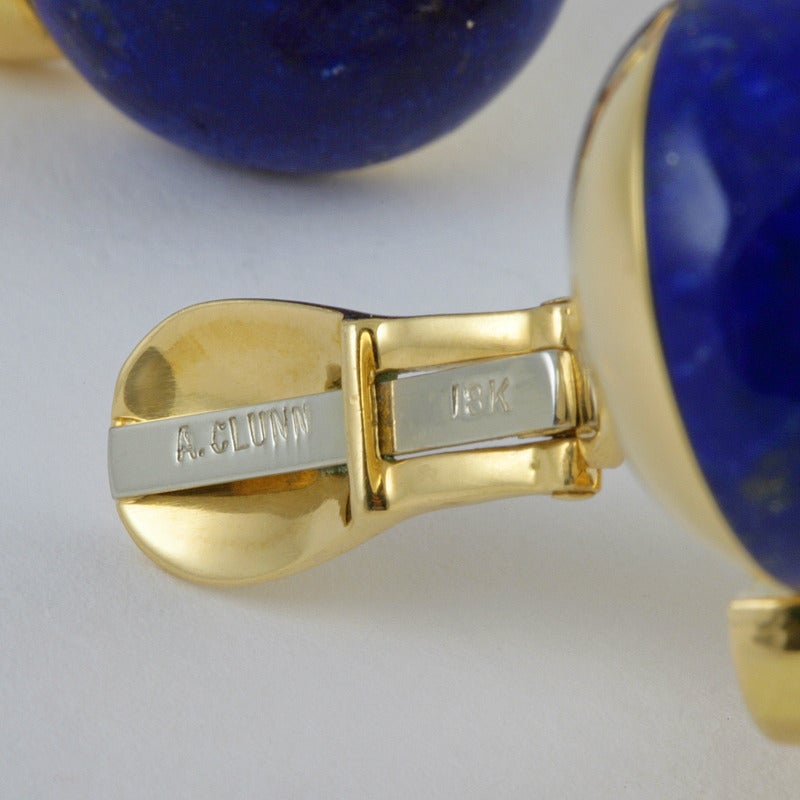 A pair of 18kt lapis, gold and enamel A. Clunn earrings.  The button shaped top portion is a bezel set lapis cabochon that is intersected by the diamond shaped lower portion of enameled red with bands of 18kt gold at each corner. Circa 1960-1970.