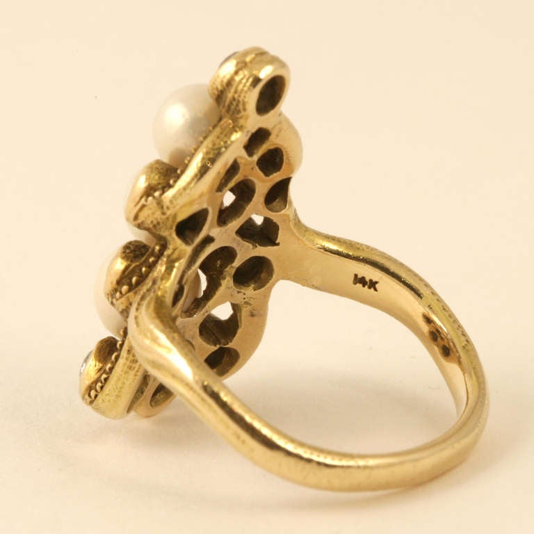 An American Art Nouveau 14 karat gold ring with diamonds and natural  freshwater pearls. The ring has a 8 old European-cut diamonds with an approximate total weight of .80 carats, 3 natural freshwater pearls measuring 5.1 mm, 5.2 mm, 6.2 mm. Circa