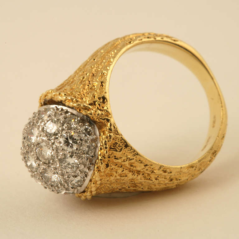 An 18 karat gold and platinum ring with diamonds by Tiffany & Co. Made in Germany. The ring centers on a pave ball of 26 round-cut diamonds with an approximate total weight of 1.85 carats. Circa 1970s. 

Signed, “Tiffany & Co”, “18kt”, “Germany”.
