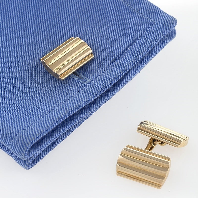 A pair of American Mid-20th Century 14 karat gold cuff links by Tiffany & Co. The cuff links are designed in a rectangular, dimensional ridged motif.  Double sided. Circa 1950’s.

Signed, “Tiffany & Co” “14 karat”. 

(MG #16421)