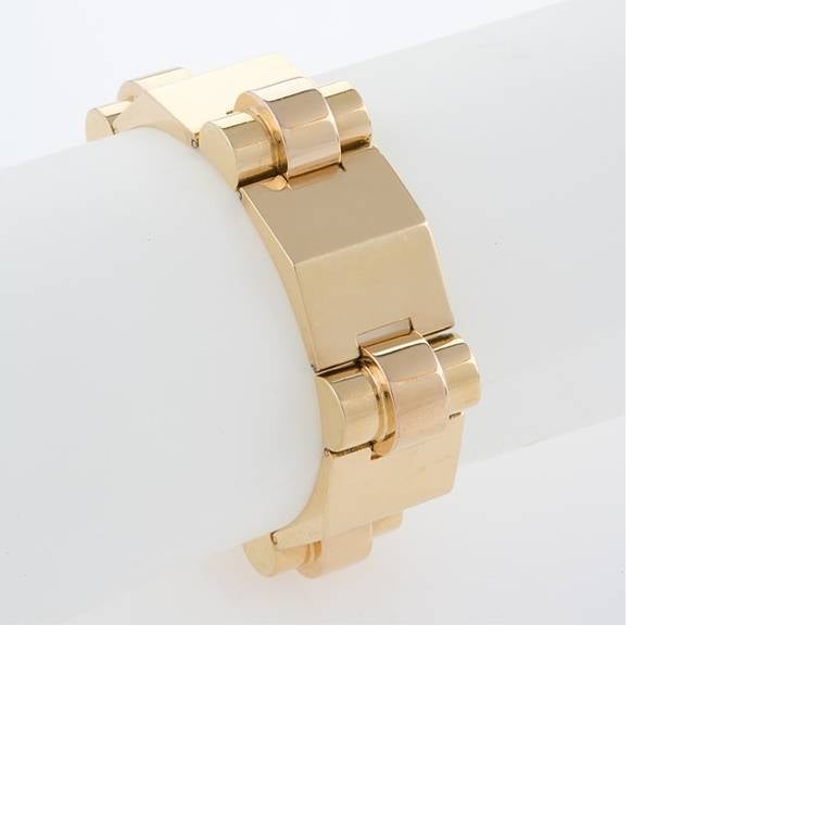 A French Retro 18 karat gold bracelet. The ‘tank track’  bracelet has plaques separated by a circular three dimensional rod shape plaques. Circa 1940’s. 

(MG #13793)