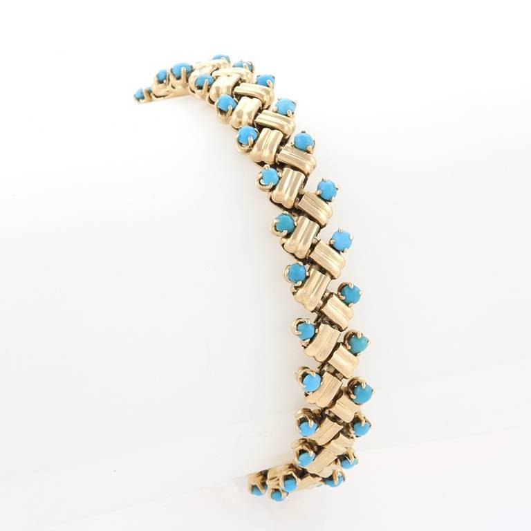 A French Mid-20th Century 18-karat gold bracelet with turquoise by Van Cleef & Arpels. The bracelet has 52 prong set cabochon turquoise stones set into polish gold links. The bracelet is from the 'Grain of Rice' collection.  Circa 1953.

Similar