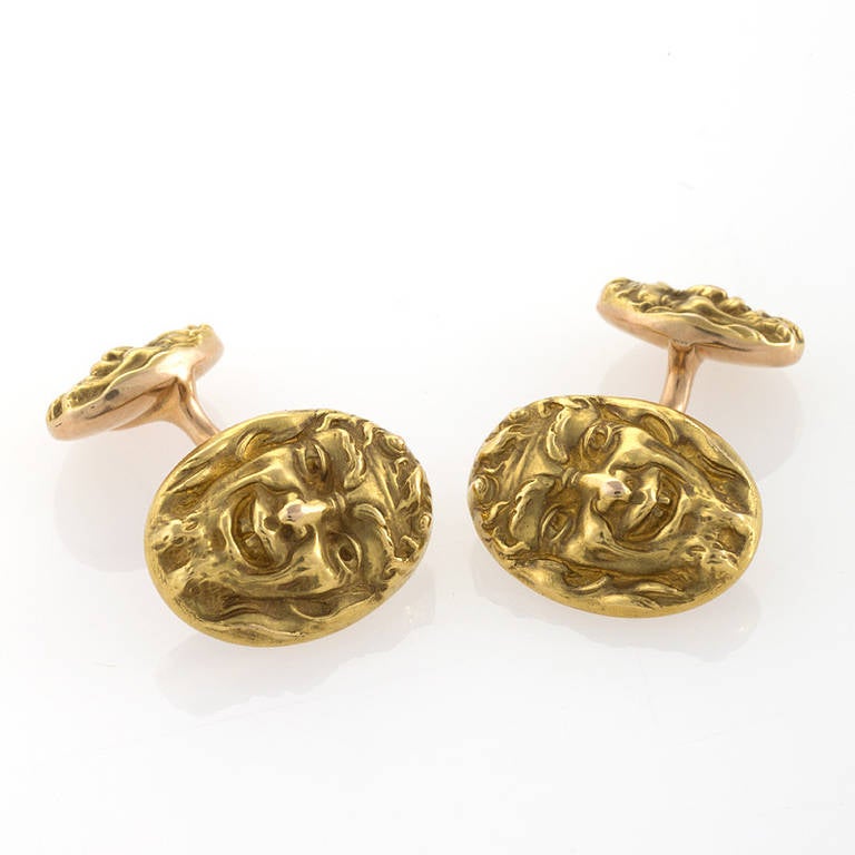 A pair of American Art Nouveau 14 karat gold cufflinks by Krementz and Co. The gold repousse cufflinks portray the Faustian image of Mephistopheles. Double sided, with a smaller repousse back link. 

(MG Inventory #CS-15127)