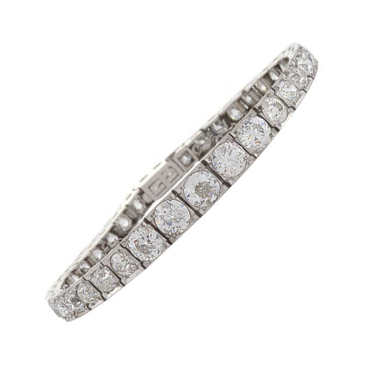 A French Art Deco diamond and platinum bracelet. This line bracelet has 38 round Old European box-set diamonds with an approximate total weight of 12.75 carats, I/J color, VS-SI clarity. The bracelet centers on a .90 carat Old European cut diamond