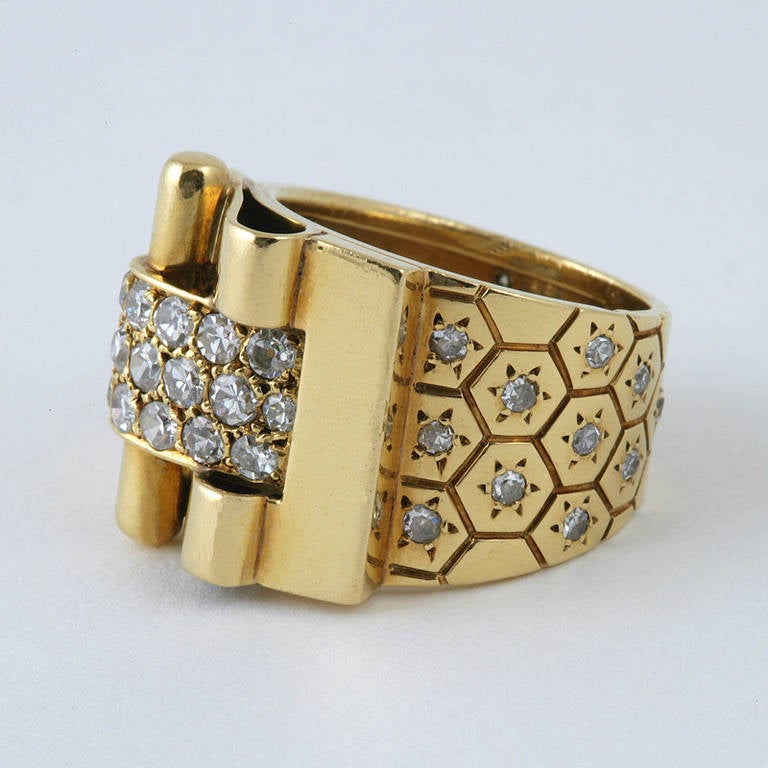A French Retro 18 karat gold “Ludo Hexagone” ring with diamonds by Van Cleef & Arpels. The buckle ring features  43 round cut diamonds  with an approximate total weight of 1.35 carats. Circa 1936. 

Signed, “#47038”, French control marks, “Van
