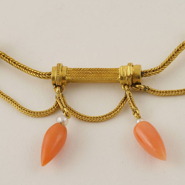 An Antique French Etruscan Revival 18 karat gold swag necklace featuring 19 coral drops and 19 seed pearls.  (MG Inventory # N-13191).