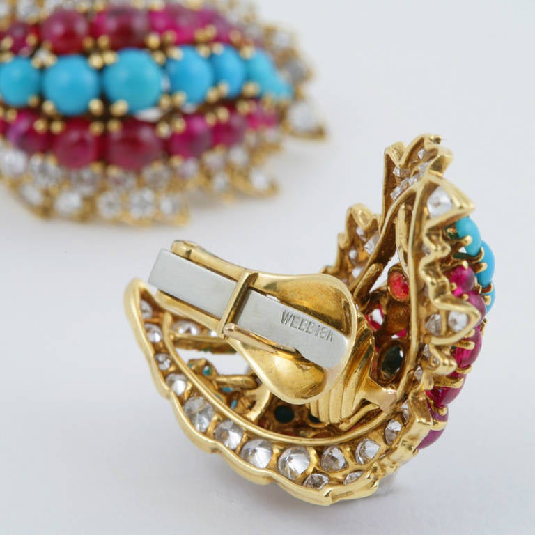 A pair of American Mid-20th Century 18 karat gold earrings with diamonds, rubies and turquoise by David Webb. The earrings have 94 round cut diamonds with an approximate total weight of 2.00 carats, 32 cabochon rubies with an approximate total