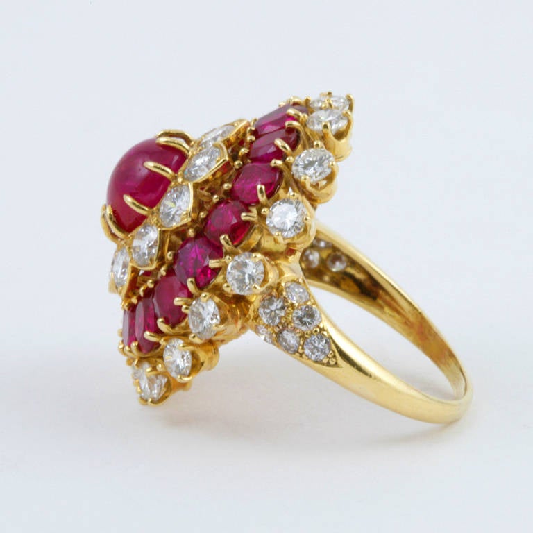 A fantastic Indian-inspired 18 karat gold, ruby and diamond ring by Van Cleef & Arpels, featuring a center cabochon ruby with an approximate total weight of 3.75 carats, surrounded by 38 diamonds with an approximate total weight of 3.45 carats and