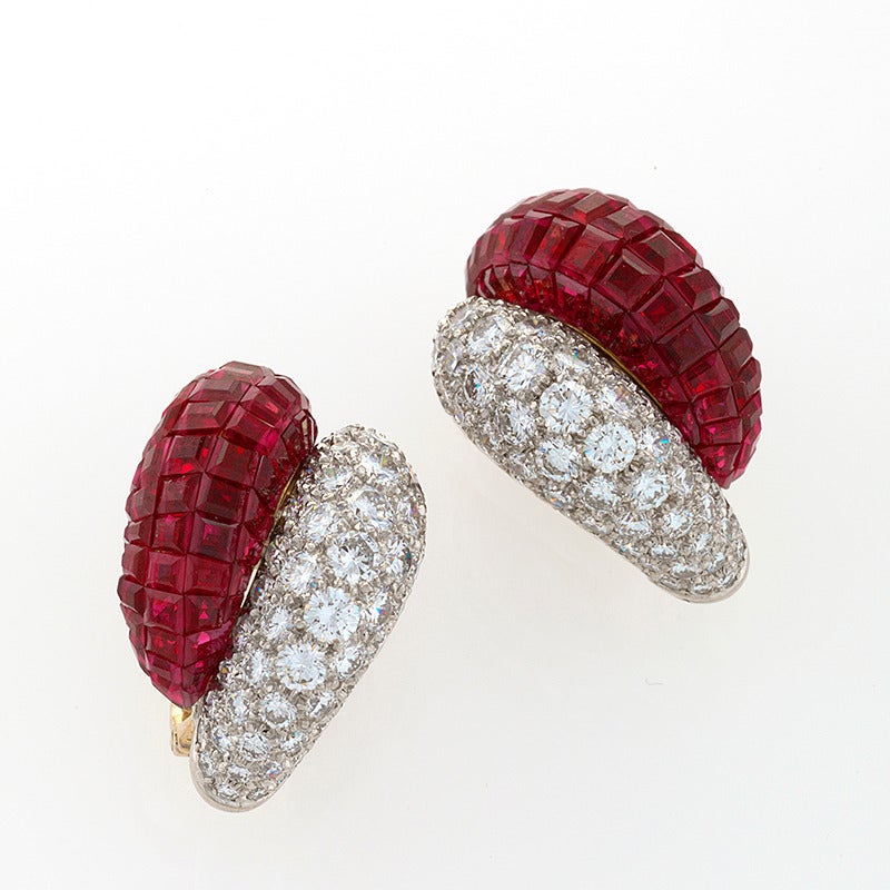 A pair of French Mid-20th Century 18 karat gold and platinum earrings with diamonds and rubies by Van Cleef & Arpels. These 