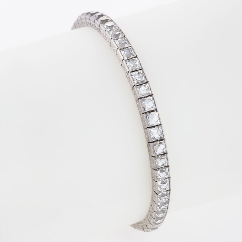 An American Art Deco platinum bracelet with diamonds by Tiffany & Co. The bracelet has 52 French cut diamonds with an approximate total weight of 20.00 carats, D/E color, VVS/VS clarity. The diamonds are channel set in platinum, forming an